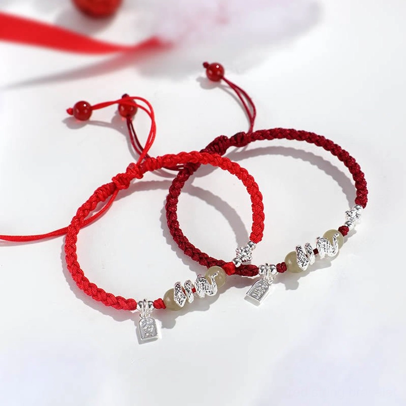 Pair of snake year red string bracelets with adjustable sliding knots and jade beads