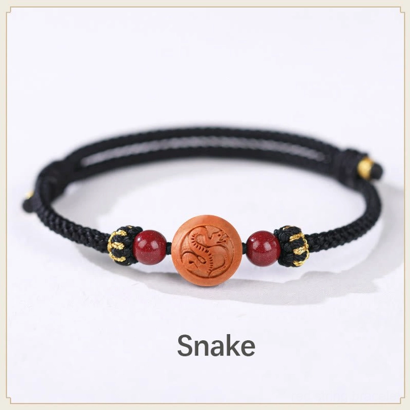 Snake zodiac peach wood black rope bracelet - enigmatic wisdom and intuition charm