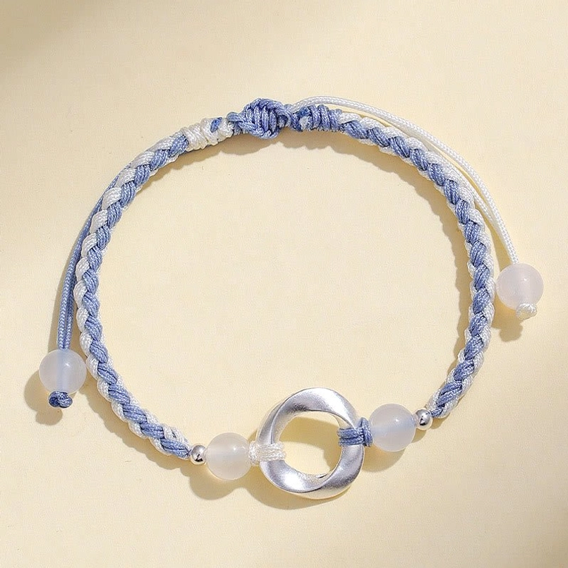 Sterling silver 925 white agate Möbius bracelet with blue-white braided cord, front detail view