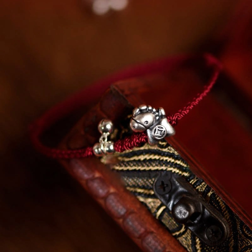 Sterling silver bell charm pendant detail on Year of the Horse red string bracelet