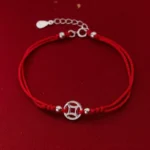 925 sterling silver hollow copper coin red string bracelet front view on dark red background