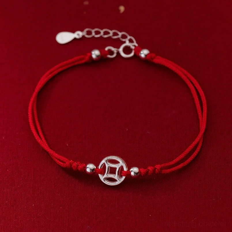 925 sterling silver hollow copper coin red string bracelet front view on dark red background