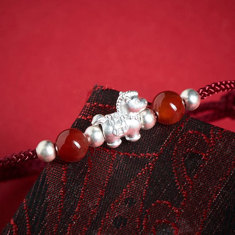 999 sterling silver horse charm detail red agate bracelet pendant close-up