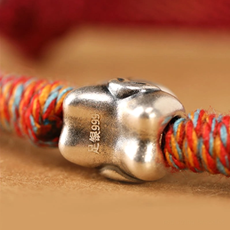 Macro close-up of 999 sterling silver horse charm with matte finish and engraved coin pattern detail