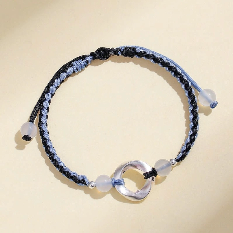 Premium 925 sterling silver white agate Möbius bracelet with braided string, top-side flat view