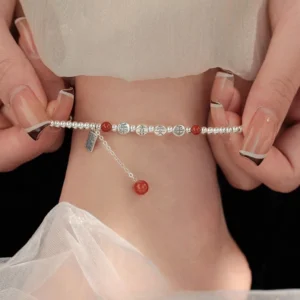925 sterling silver red agate peace and joy blessing anklet worn on ankle with sheer fabric backdrop