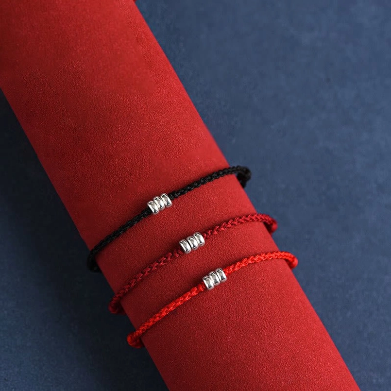 Sterling silver red string bracelet collection showcasing multiple colors and styles available