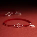 925 sterling silver dark red string bracelet with lucky fortune charm overhead view