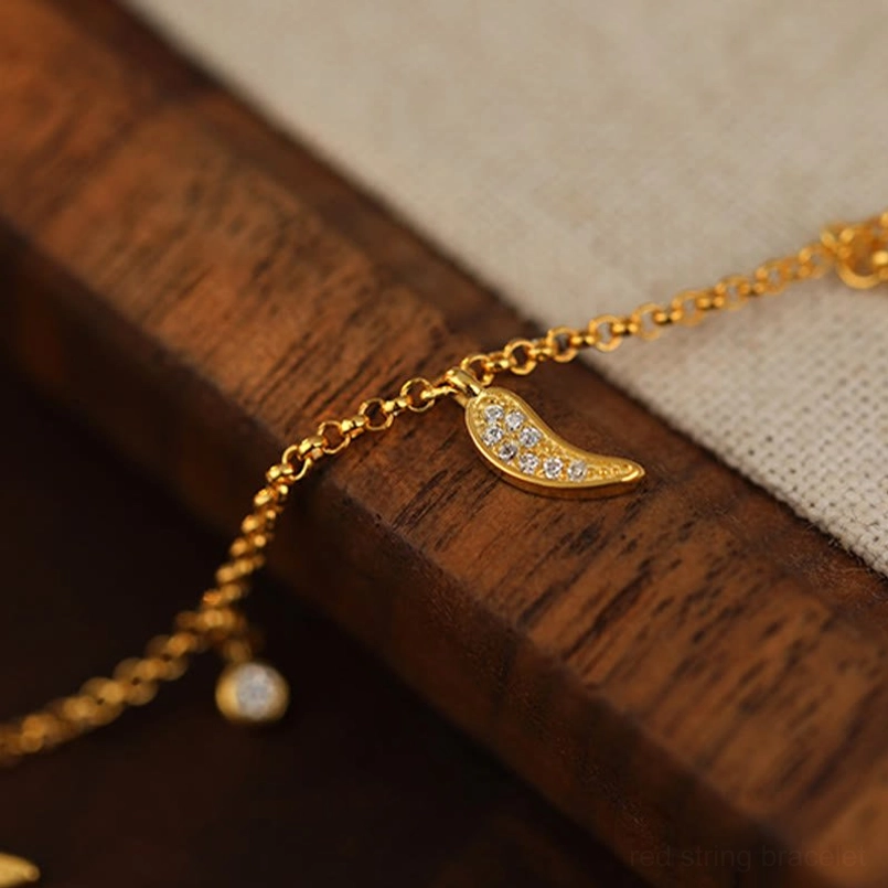 Close-up detail of 925 sterling silver zircon-encrusted pepper charm and sparkling zircon drop