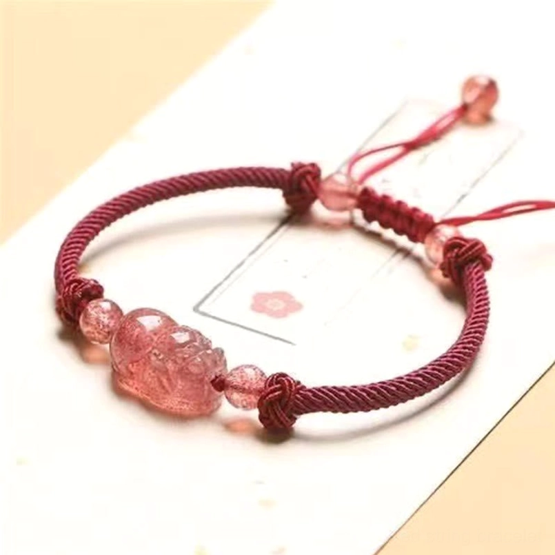 Natural strawberry quartz accent beads and tightly woven red string knots on Pixiu bracelet