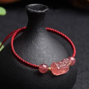 Strawberry Quartz Pixiu red string bracelet with gold spacers, side close-up view