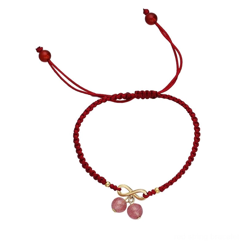 Handmade strawberry quartz red string bracelet flat lay showing full adjustable pull knots