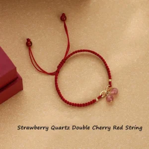 Strawberry quartz endless knot red string bracelet flat lay with adjustable tie closure on light background