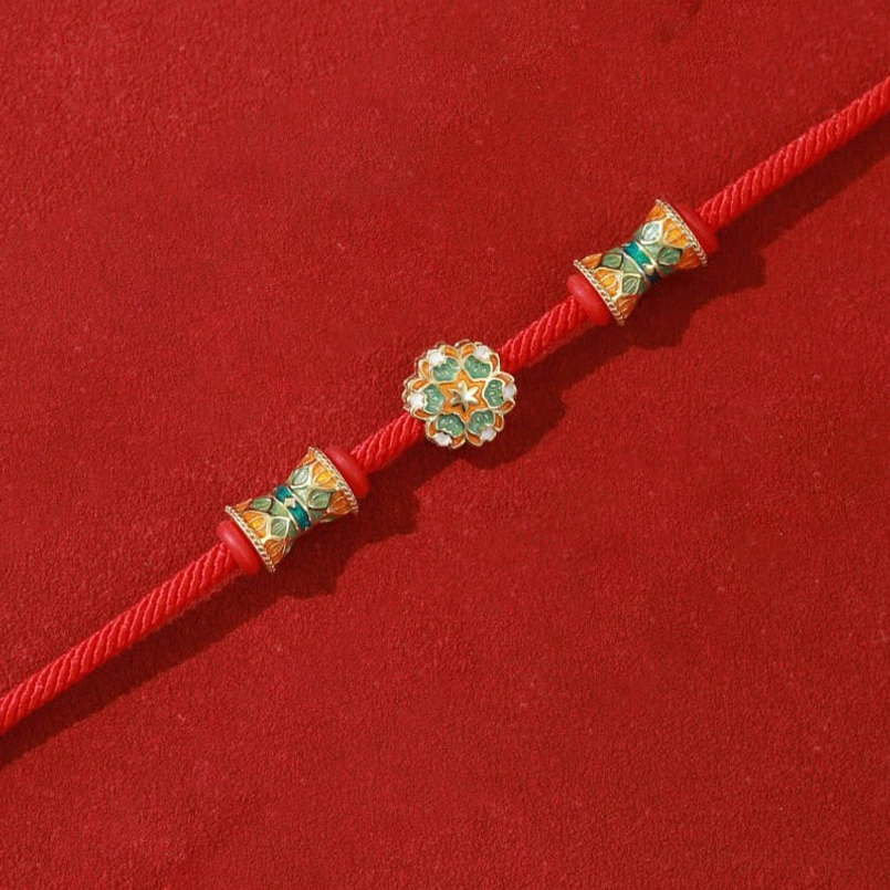 Symmetrical enamel bead design Dunhuang lotus red string bracelet flat lay