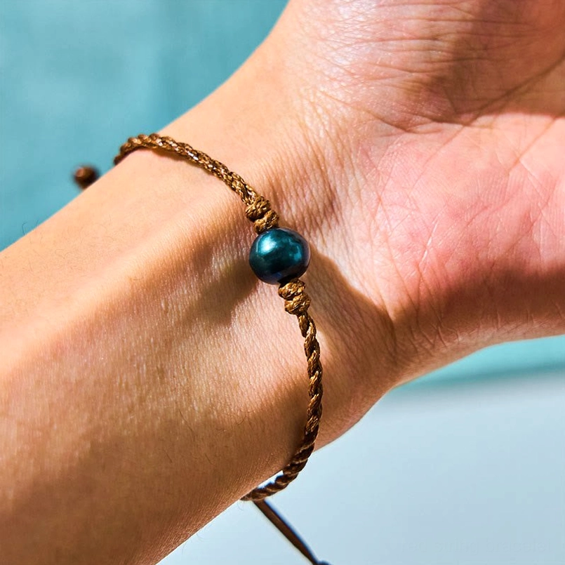Tahitian black pearl wax rope bracelet worn on wrist - adjustable wisdom protection bracelet side view