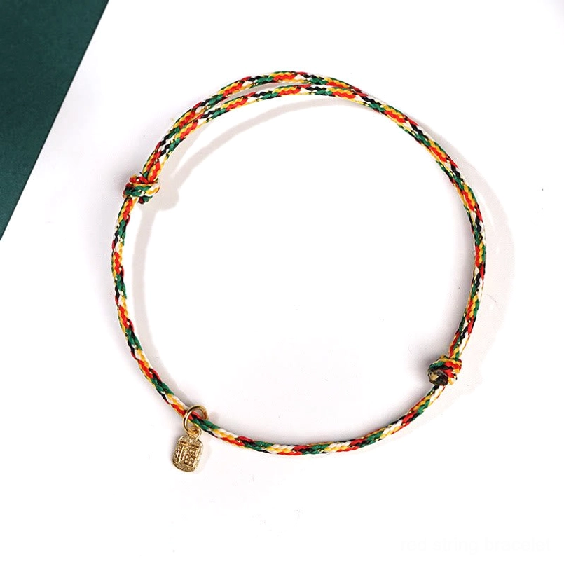 Thin multicolor braided Fu character lucky bracelet flat view on white background