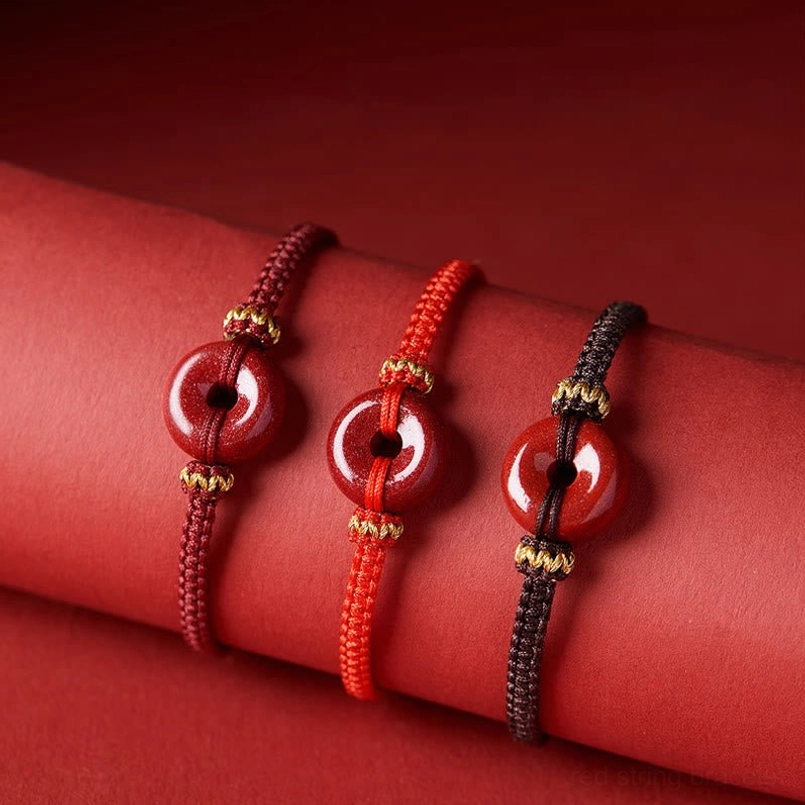 3-color cinnabar peace buckle red string bracelet flat lay close-up