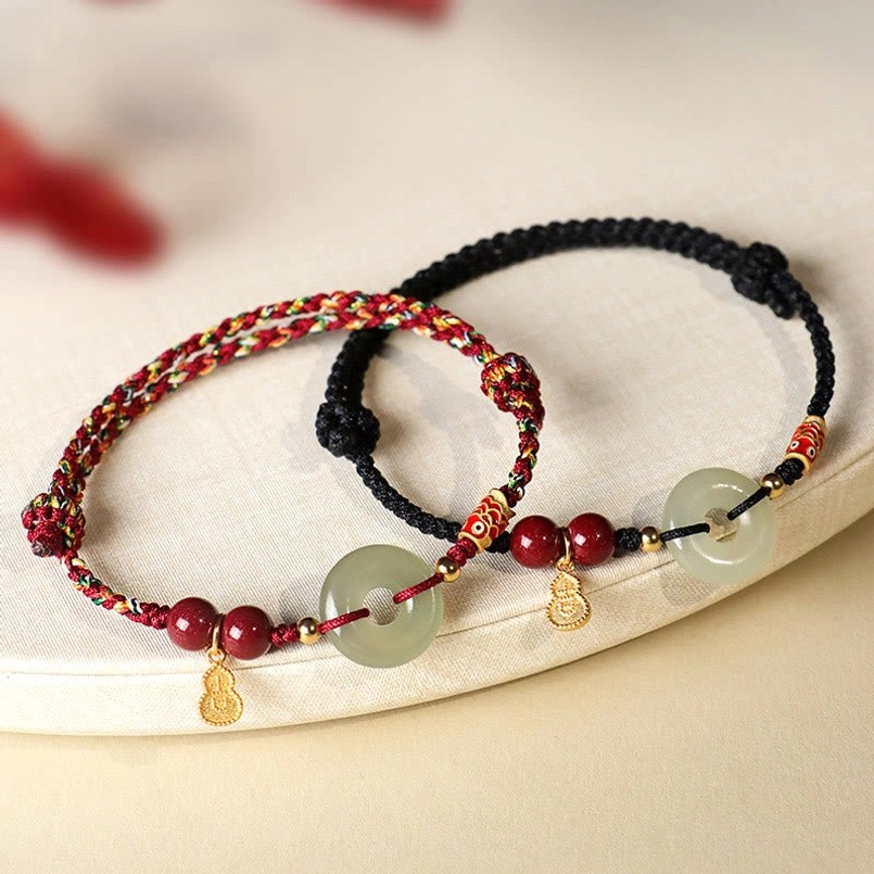 Three color options red dark red black string protection bracelets group shot