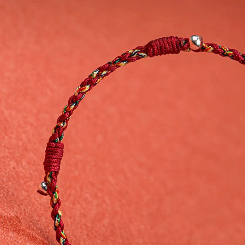Close-up detail of Tibetan bamboo protection bracelet showing tight weave texture and metal bead decorations