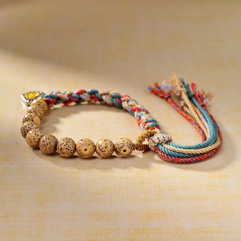 Handcrafted colored rope Bodhi bracelet with metal amulet pendant - side angle