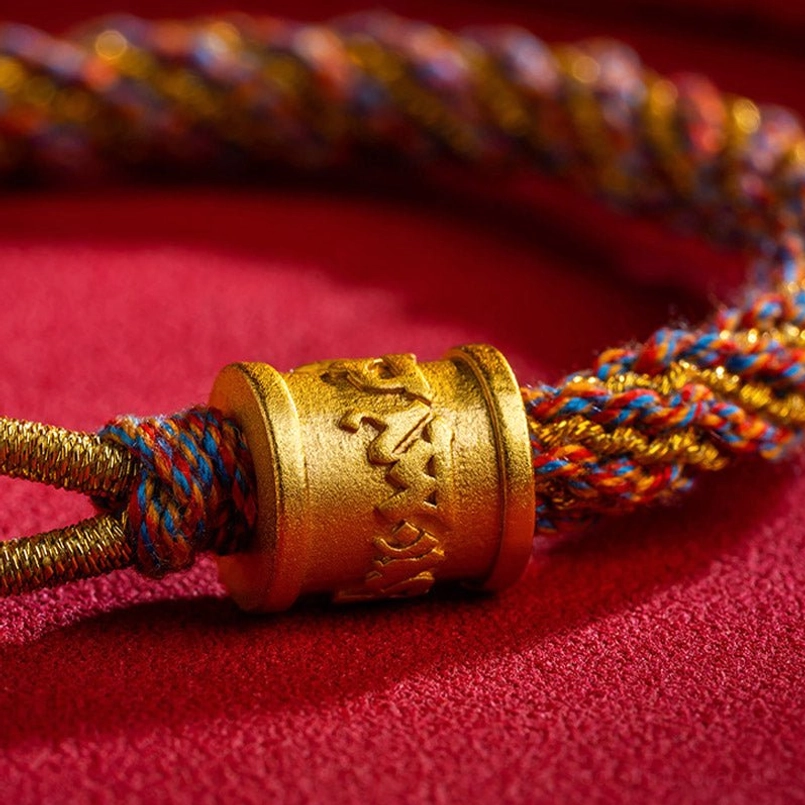 Handcrafted Tibetan bracelet gold barrel bead with multicolor braided rope and metal knot hardware