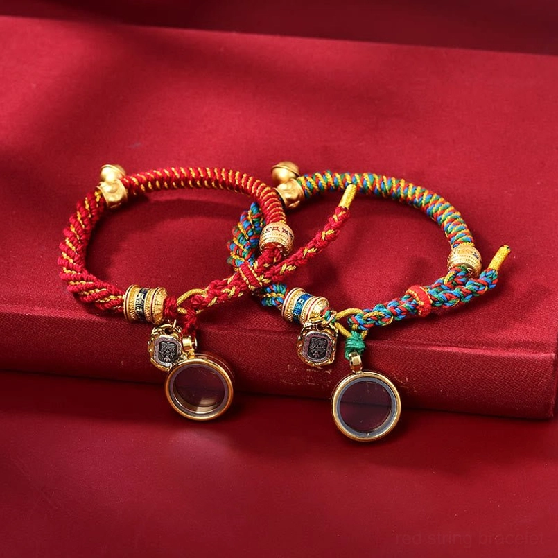 Two Tibetan Om Mani Padme Hum bracelets with mixed color and solid red braided cords and metal locket charms