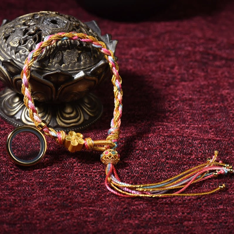 Mini Tibetan handmade braided lucky string bracelet with simple braid design, small tassel and metal pendant