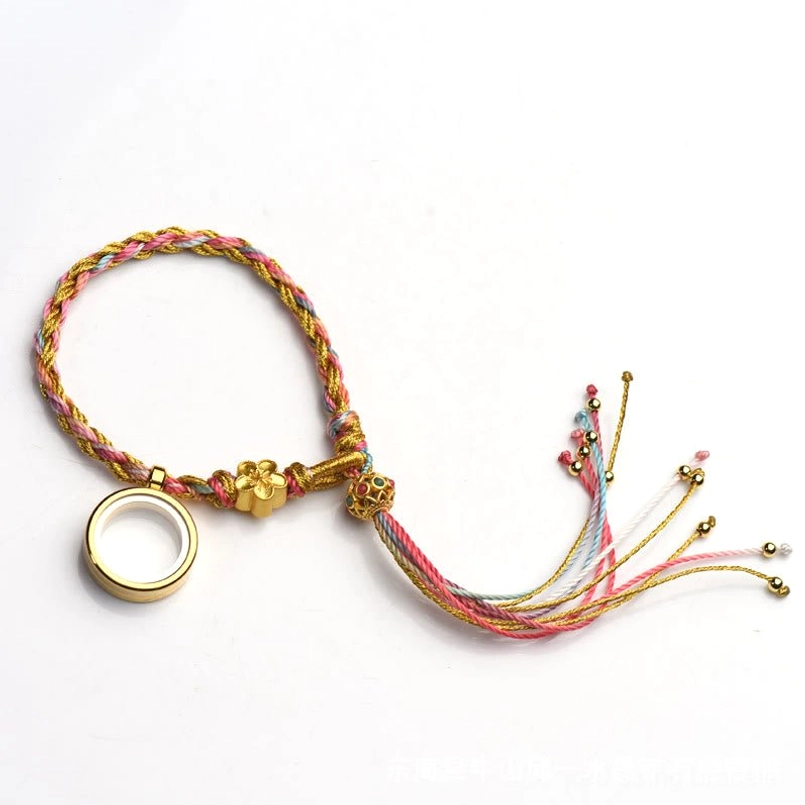 Tibetan lucky braided string bracelet worn on wrist showing single wrap style with metal decorations and long tassel
