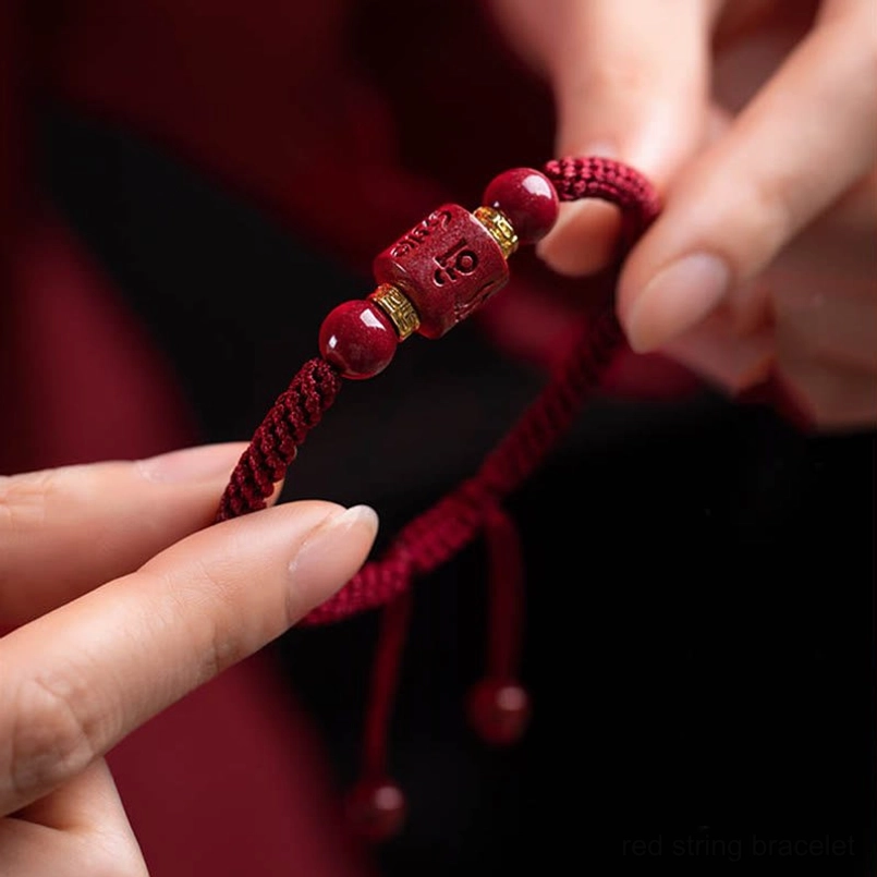 Handheld om mani padme hum cinnabar bracelet showing braided rope texture