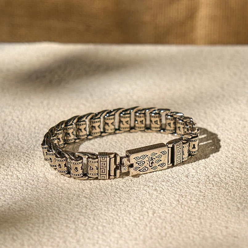 Full view of Tibetan Om Mani Padme Hum copper bracelet flat lay