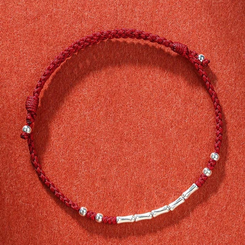 Dark red Tibetan multicolor bamboo braided protection bracelet with spiritual symbolism