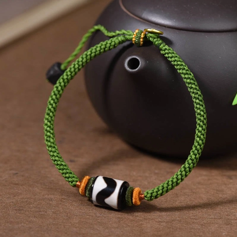 Handmade Tibetan Dzi bead protection bracelet braided green cord with decorative spacers