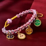 Three quarter close up of Tibetan five gods of wealth multicolor braided lucky string bracelet on red velvet background