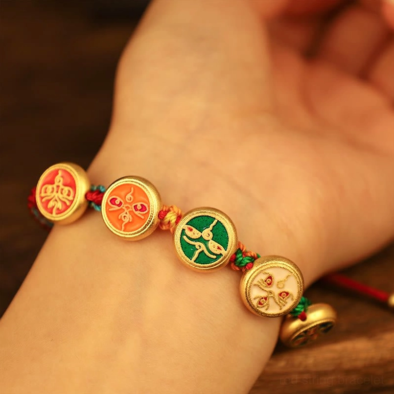 Tibetan Five Gods of Wealth bracelet worn on wrist showing traditional fortune symbols and comfortable fit