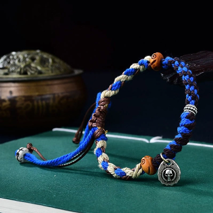 Handwoven Tibetan Garuda bracelet showing natural materials ox bone and silver pendant