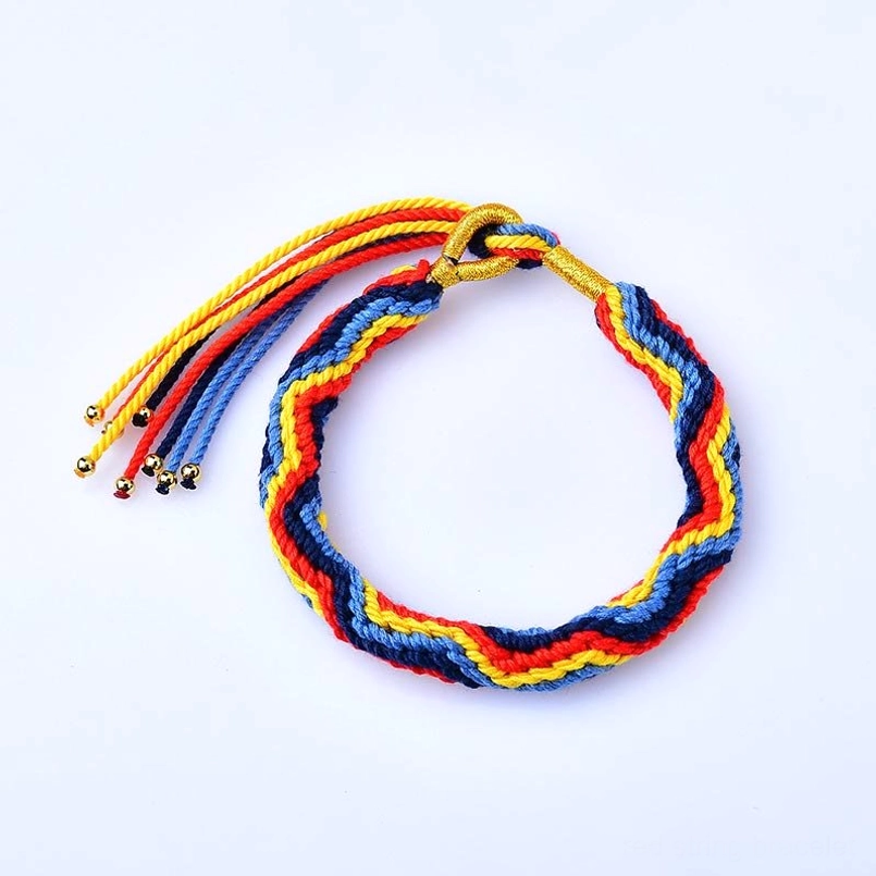 Zig zag design Tibetan colored rope luck bracelet on white surface