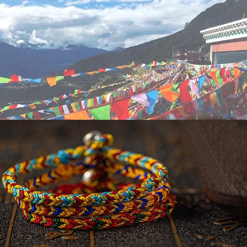 Stacked multicolored braided bracelets with Tibetan prayer flags in mountain village setting