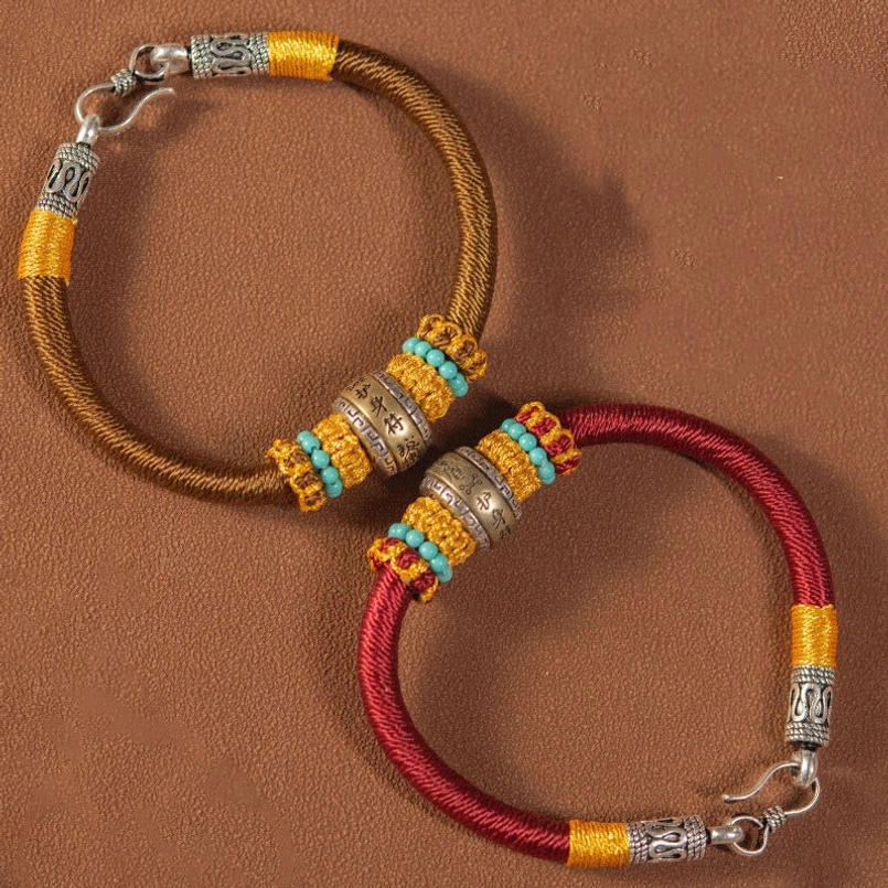 Red and brown handmade Tibetan amulet bracelets side by side comparison flat lay