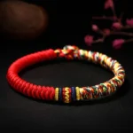 Handmade Tibetan King Kong Knot red string bracelet with multicolor braided accents and floral styling