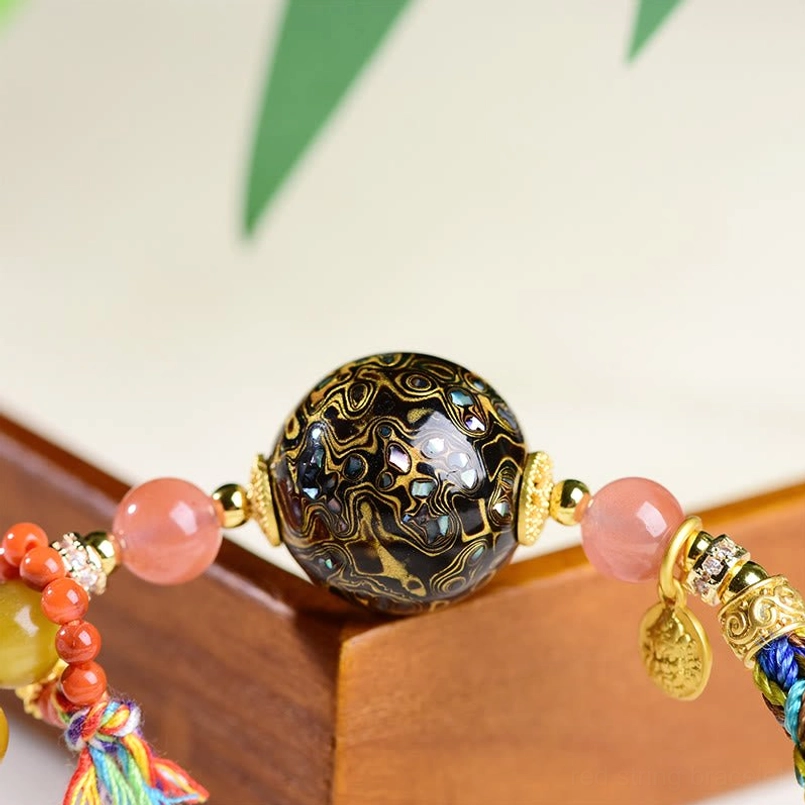 Natural Tibetan lacquer bead close up showing traditional craft pattern detail