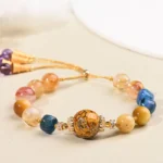 Tibetan lacquer bead and crystal power bracelet with tiger eye and amethyst stones, adjustable purple tassel clasp
