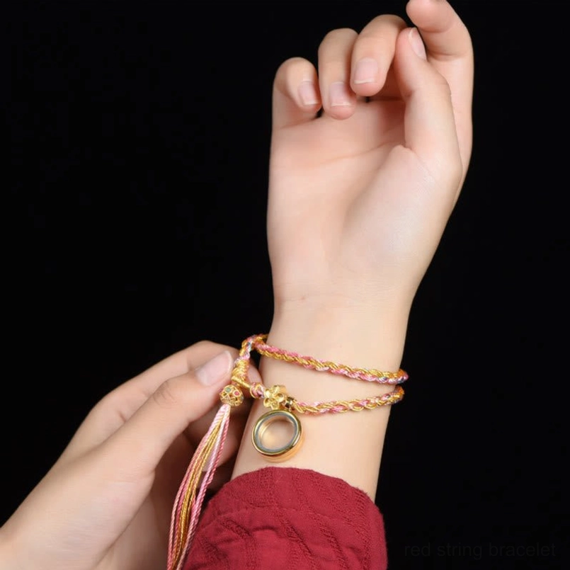 Tibetan lucky braided string bracelet worn on wrist showing double wrap style with matching decorative elements