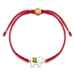 Tibetan lucky elephant red string bracelet flat lay with gold metal clasp on white background