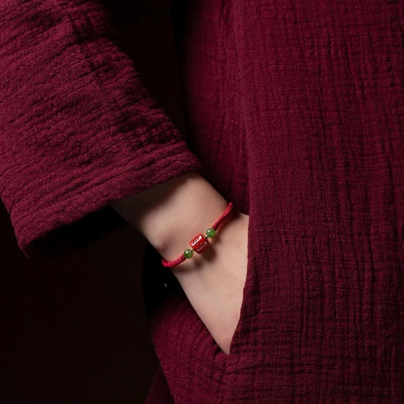 Tibetan red string bracelet worn on wrist showing fit and appearance on arm
