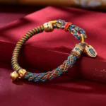 Multicolor Tibetan Om Mani Padme Hum red string bracelet with gold charms and metal bell pendant