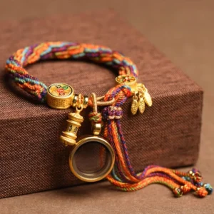 Tibetan Om Mani Padme Hum red string lucky bracelet top view on brown wooden box