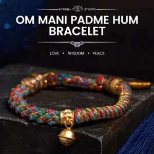 Tibetan Om Mani Padme Hum red string bracelet with Zakiram goddess charm - flat lay on dark stone