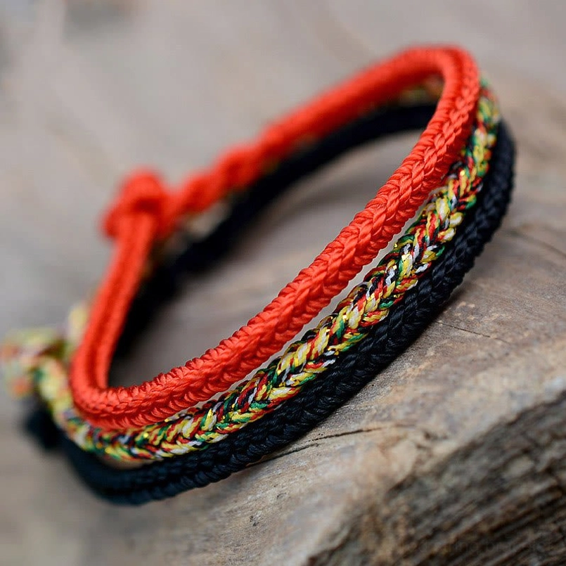 Tibetan eight thread peace knot red string bracelets multi-layer woven design overhead view
