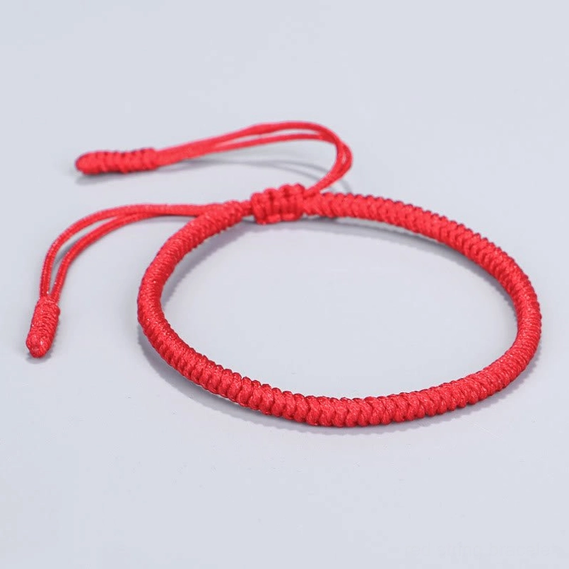 Solid deep red thick twisted woven cord bracelet central knot tassel ends protective amulet