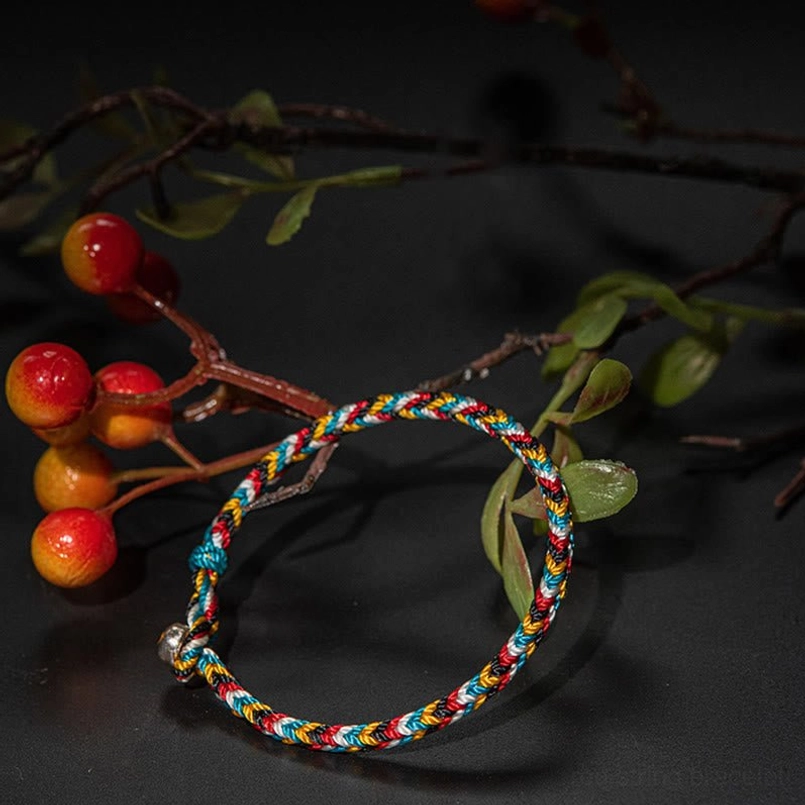 Tibetan five color woven red string bracelet side view with red berry branches